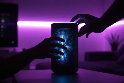 A sleek, modern AI smart speaker with a glowing LED interface.
