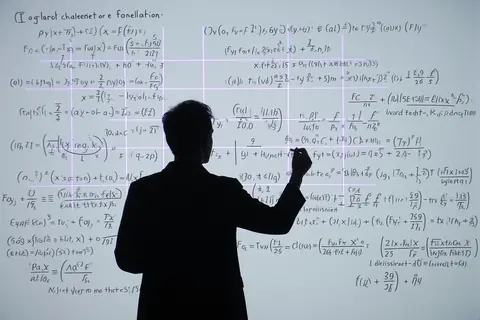 A mathematician working on complex equations with an AI interface in the background.